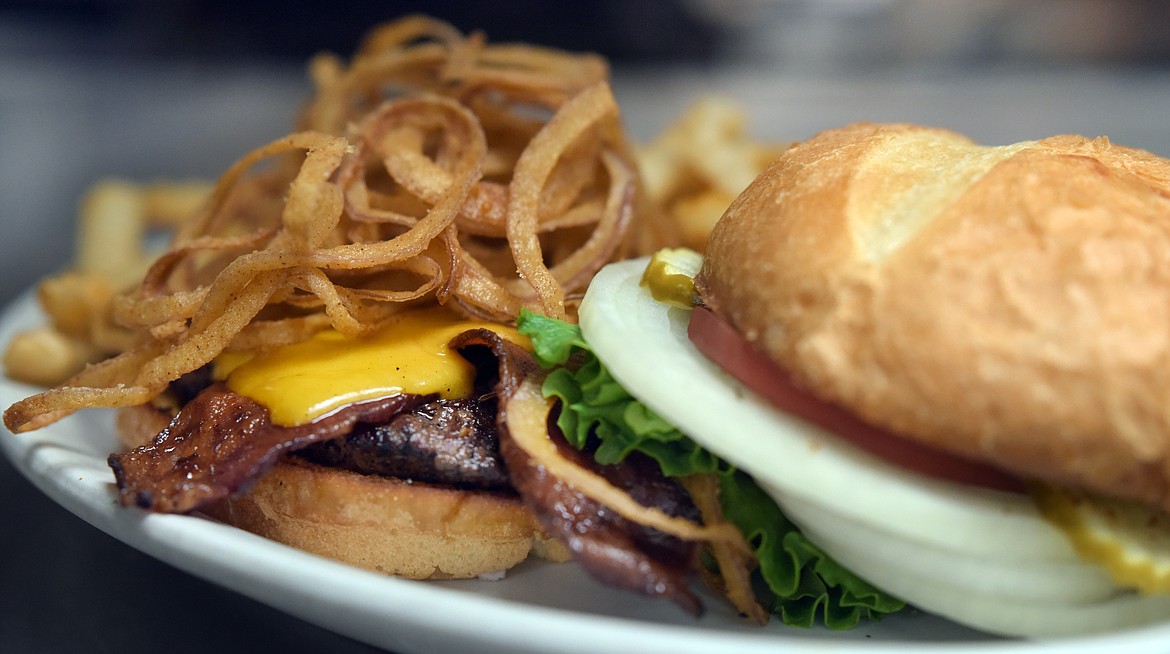 The Cowboy is one of the favorite burgers at Nickel Charlie&#146;s. It is served with cheddar, bacon, Nickel skinny rings, and chipotle barbecue sauce.