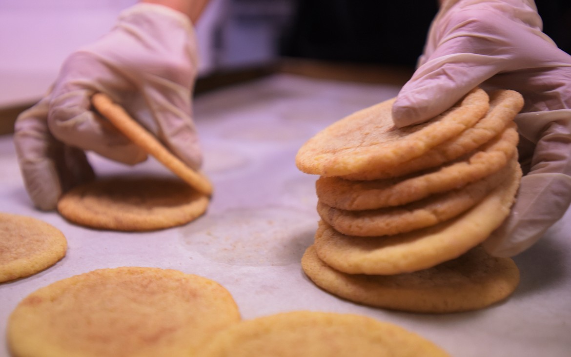 Heather Beadles scoops up two dozen snickerdoodle cookies at Enchanted Realms.