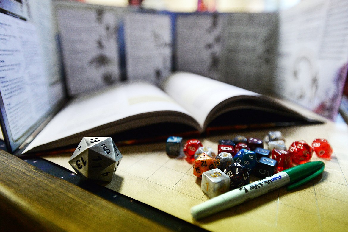 Polyhedral dice sit behind the dungeon master&#146;s screen before a game of Dungeons &amp; Dragons at Heroic Realms Hobbies &amp; Games in Evergreen.