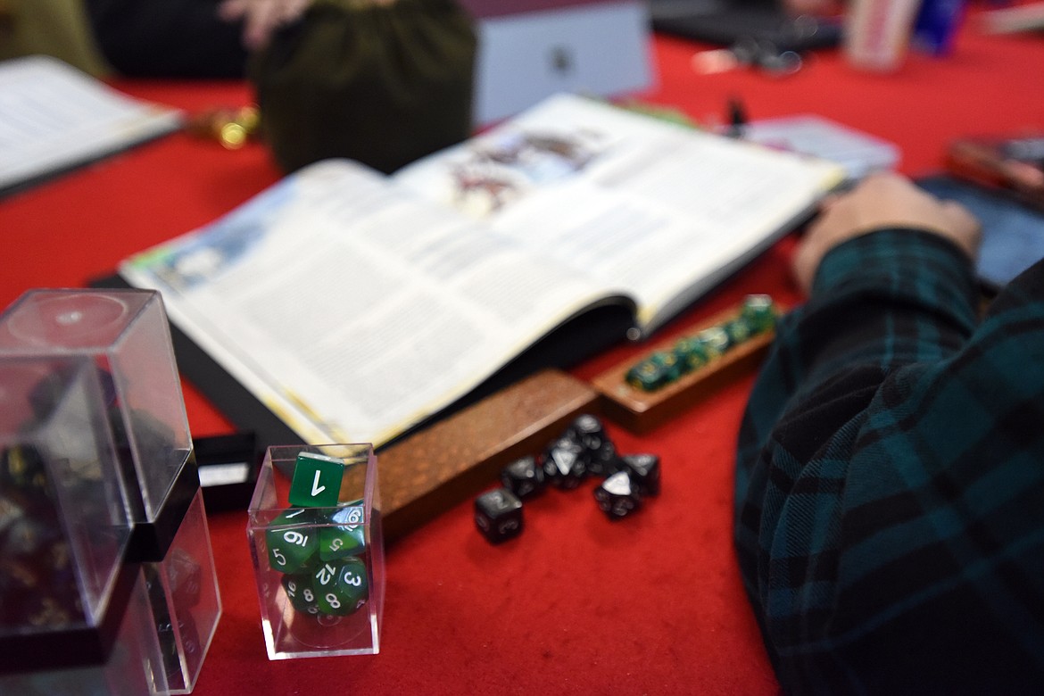 Sets of polyhedral dice sit before a participant during a game of Dungeons &amp; Dragons at Heroic Realms Hobbies &amp; Games in Evergreen on Thursday, Nov. 14. (Casey Kreider/Daily Inter Lake)