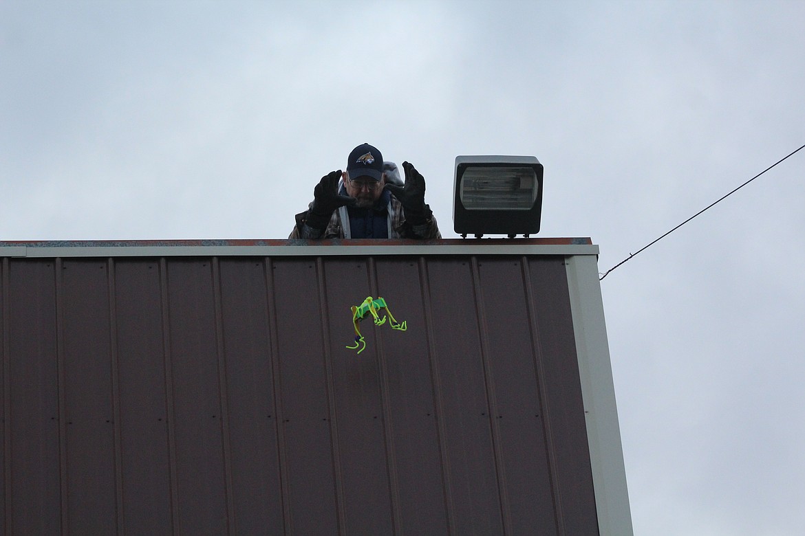 PAUL PICKERING dropping one of several devices designed to protect an egg from the concrete below. (John Dowd/Clark Fork Valley Press)