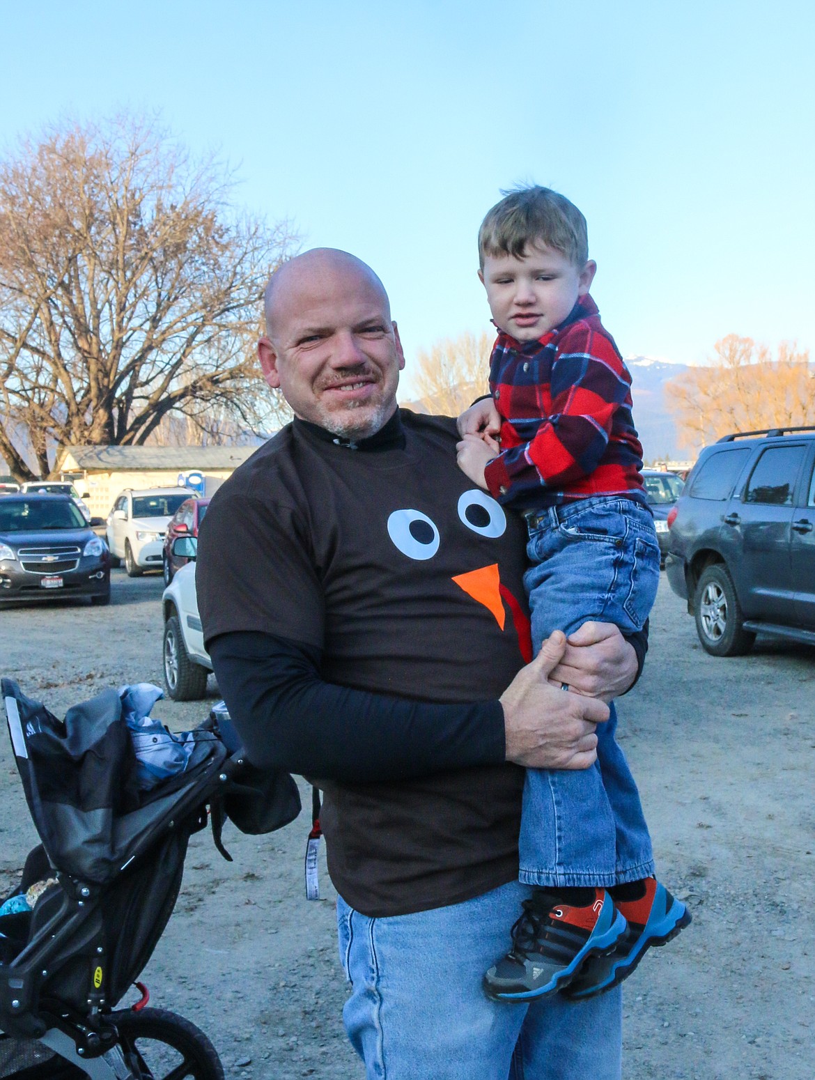 Photo by MANDI BATEMAN
Bonners Ferry Police Sergeant Wille Cowell, and his son Grayson, awaiting the start of the annual Turkey Trot.