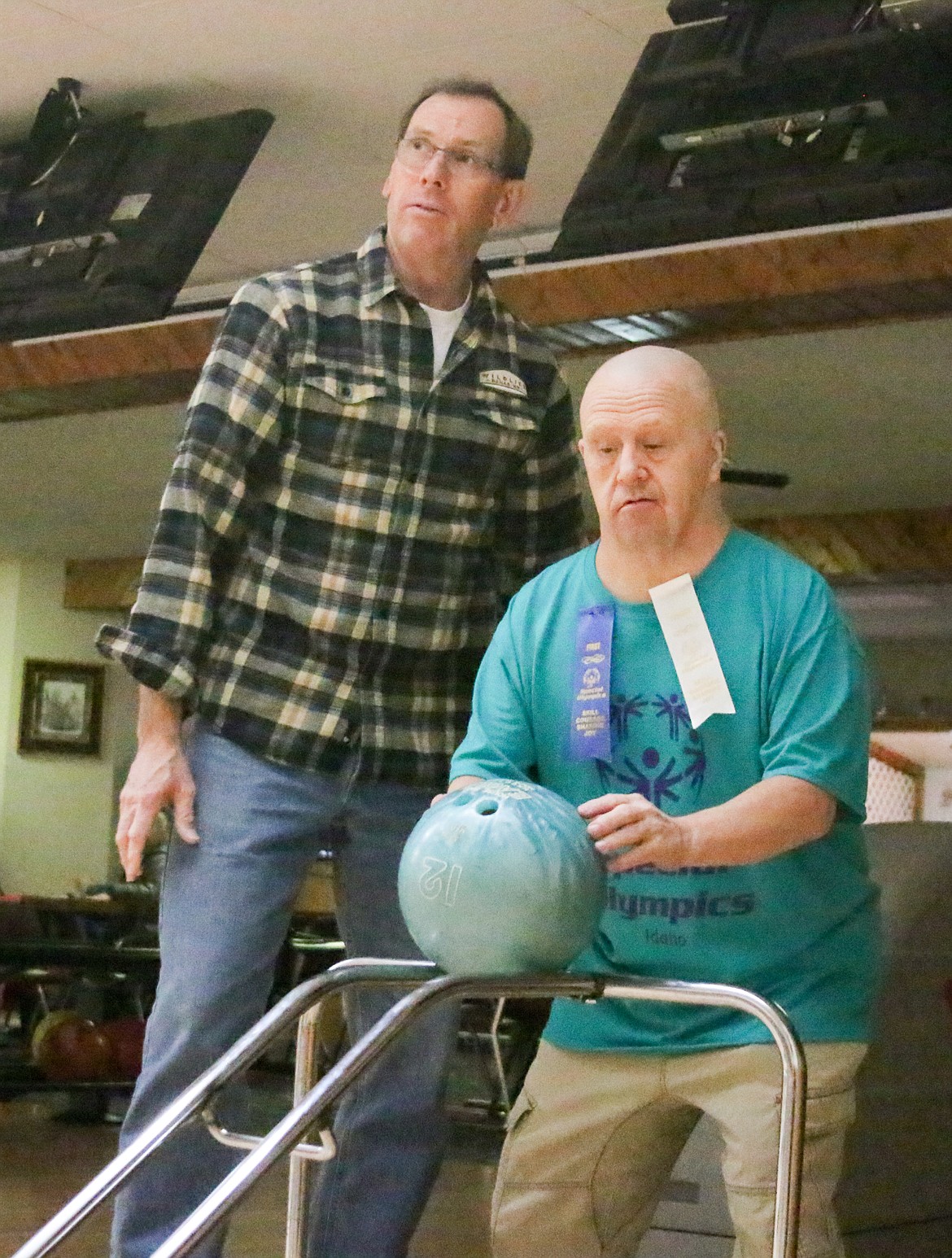 Photo by MANDI BATEMAN
Coach John Beck assists Special Olympics bowler, Nathaniel Dodge at AJ&#146;s Lanes.