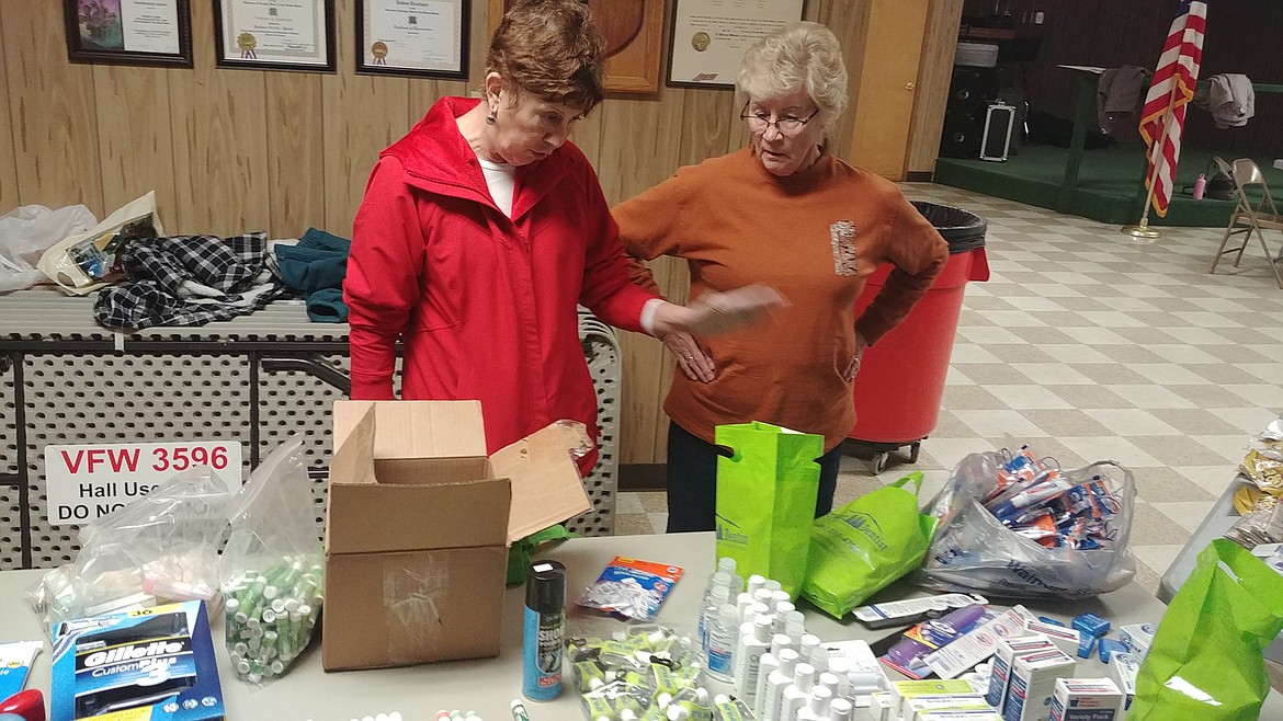 From left, VFW auxiliary members Cindy Gray and Karen Royse talk about the boxing process. (Chuck Bandel/Mineral Independent)