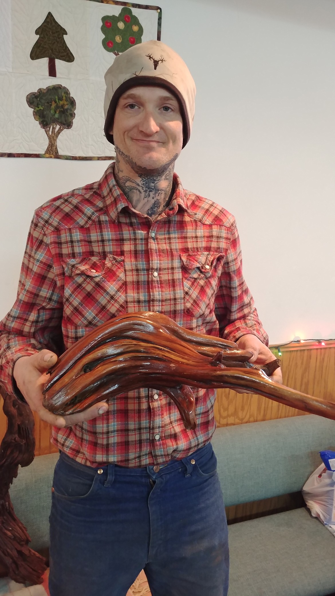 Russell McKague, of St. Regis, who turns driftwood into decorative art pieces shows off one of his pieces at the bazaar. (Chuck Bandel/Mineral Independent)