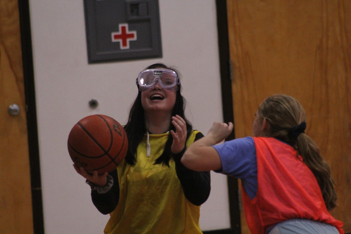 GENA DESCHAMPS being talked through the halftime game by Kaylah Standerford, last Tuesday afternoon. (John Dowd/Clark Fork Valley Press)