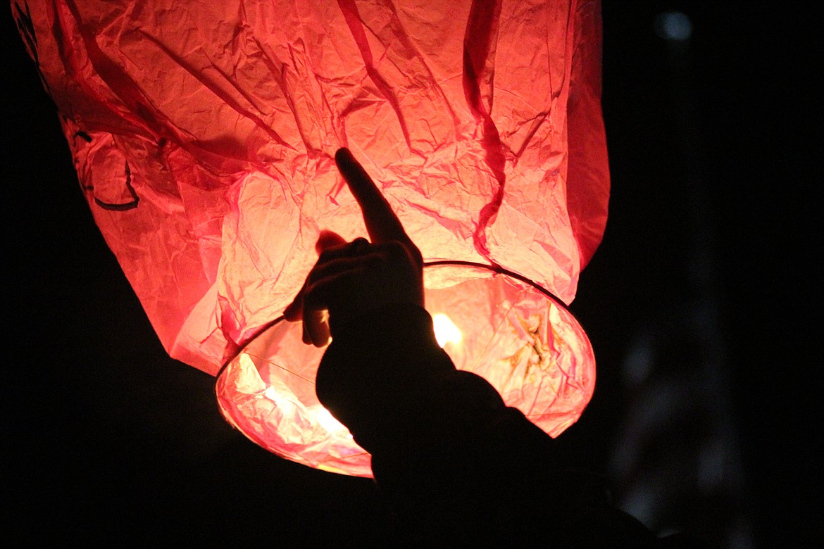 CAROL SEILHYMER points as her lantern is pulled from her hands by the wind. (John Dowd/Clark Fork Valley Press)