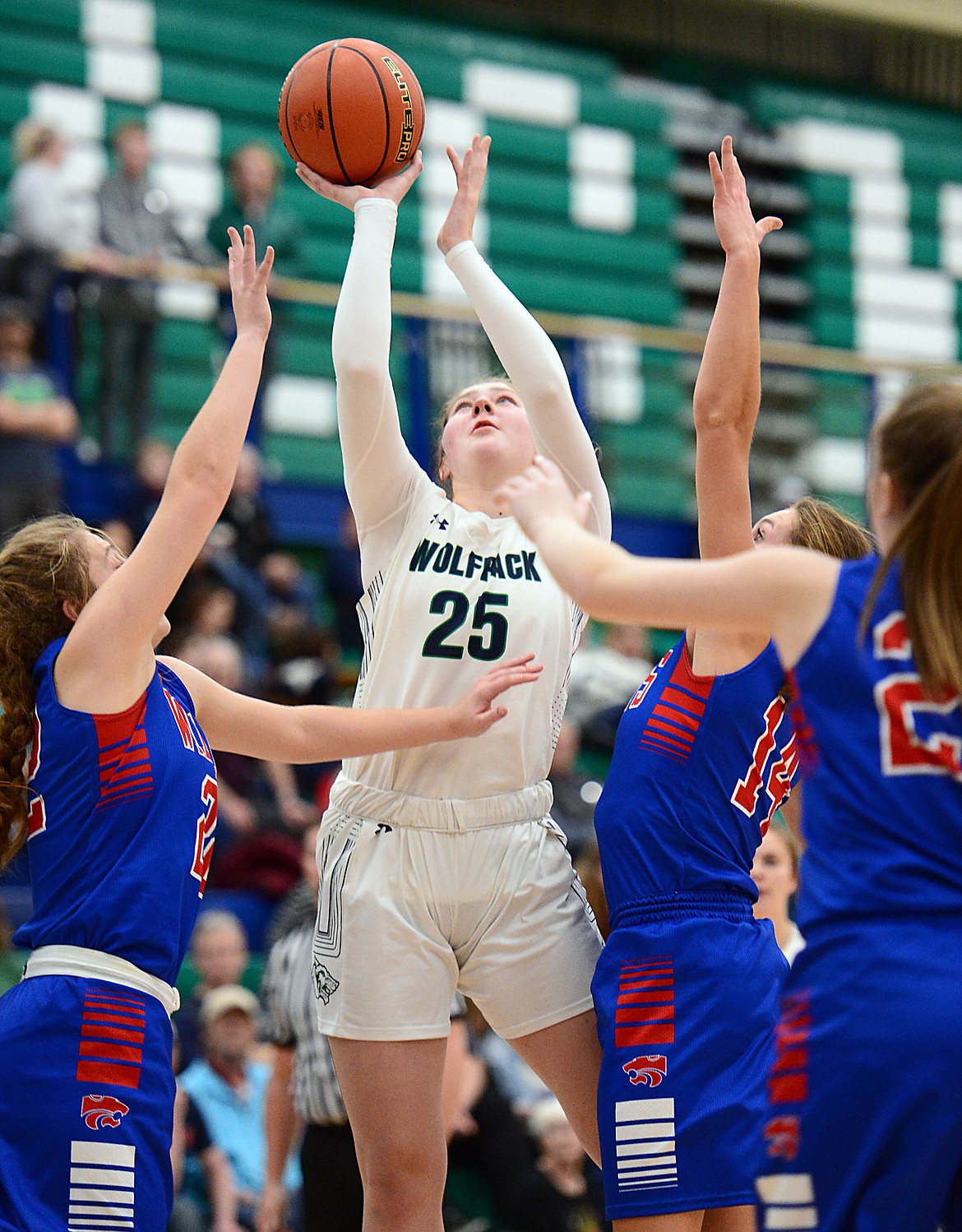 Glacier's Emma Anderson goes to the hoop between Columbia Falls defenders Hannah Schweikert, left, and Josie Windauer at Glacier High School on Thursday. (Casey Kreider/Daily Inter Lake)