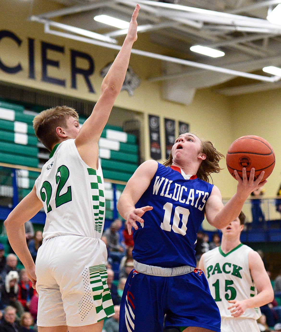 Columbia Falls' Cade Morgan drives to the hoop against Glacier's Michael Schwarz at Glacier High School on Thursday. (Casey Kreider/Daily Inter Lake)