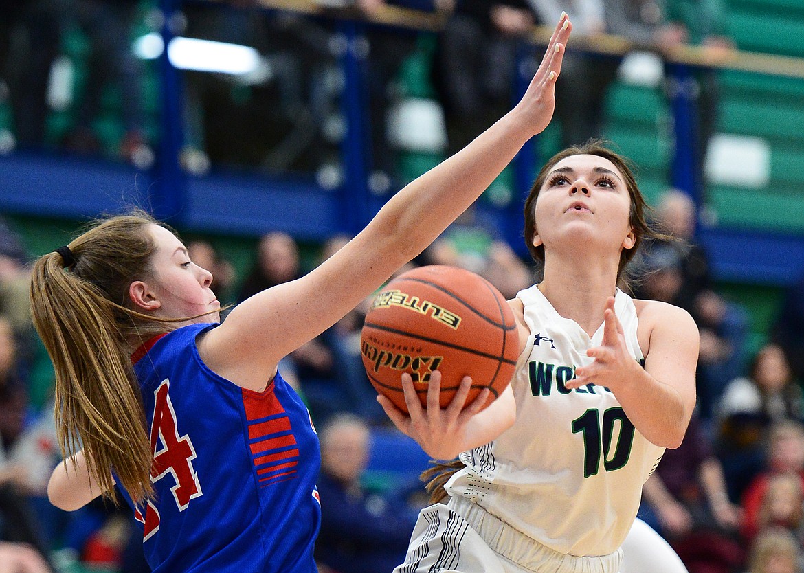 Glacier's Blayke Foppiano drives to the basket against Columbia Falls' Lauren Falkner in the second quarter at Glacier High School on Thursday. (Casey Kreider/Daily Inter Lake)