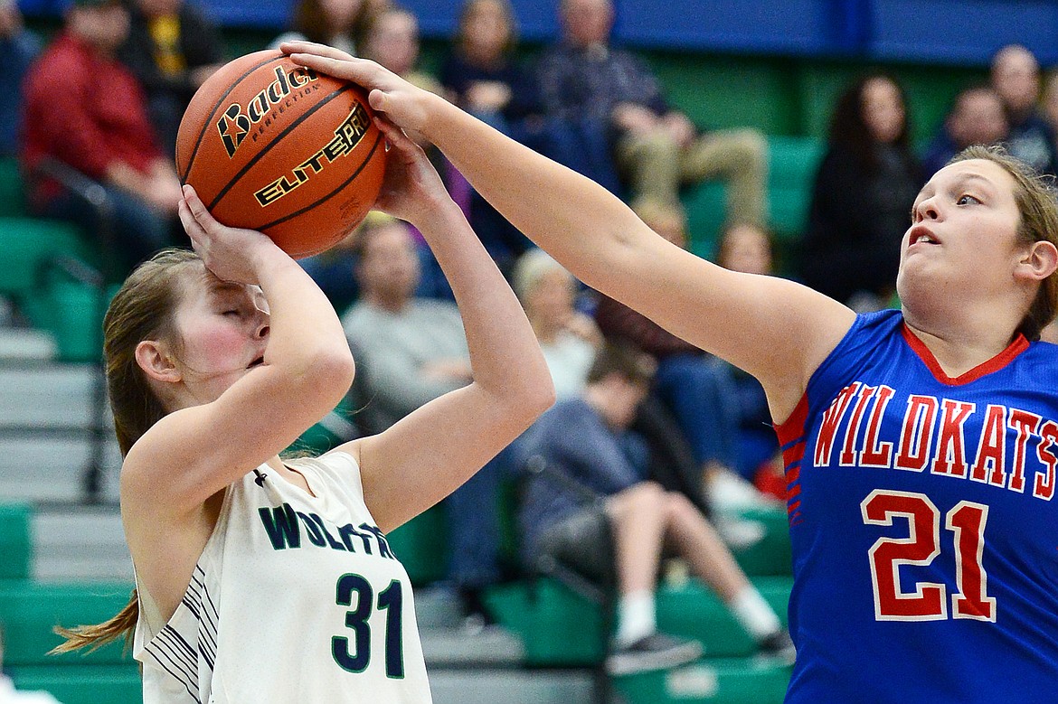 Glacier's Madeline Bishop has a shot blocked by Columbia Falls' Graceanne Sevesind in the second quarter at Glacier High School on Thursday. (Casey Kreider/Daily Inter Lake)