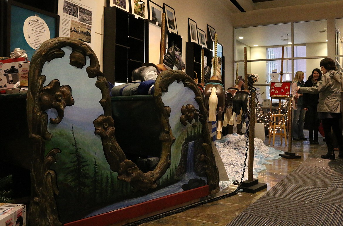 (Photo by MARY MALONE)
A Carousel of Smiles chariot with a newly painted panel, as well as some of the restored and painted ponies, are on display at Mountain West Bank in Sandpoint. There will be a champagne reception for the Carousel of Smiles at 6:30 p.m. on Thursday, Dec. 19, for the community to see the progress and different stages of restoration.