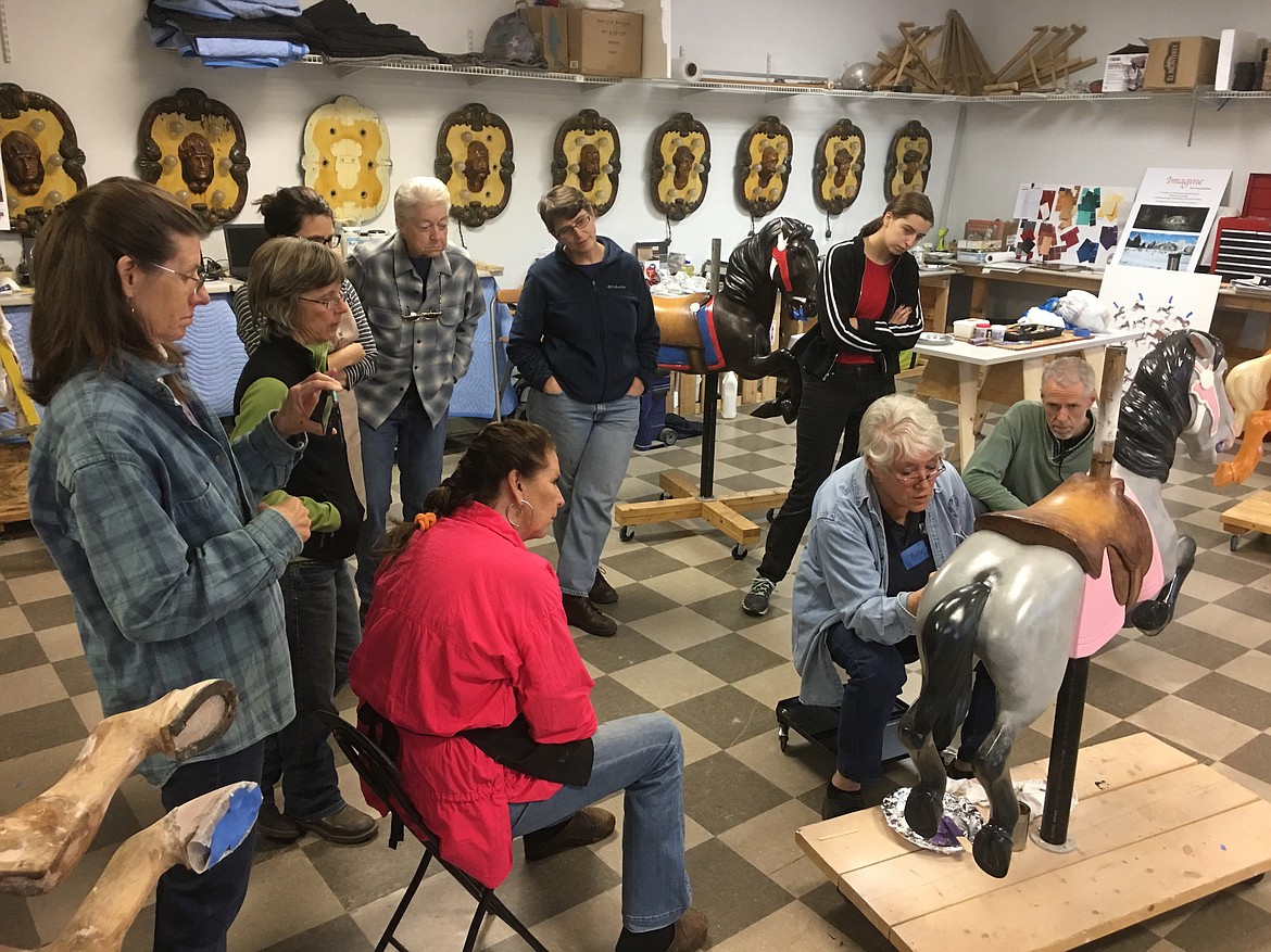 (Photo courtesy CLAY HUTCHISON)Bette Largent leads a workshop, demonstrating different painting techniques, as the Carousel of Smiles ponies go through the restoration process.