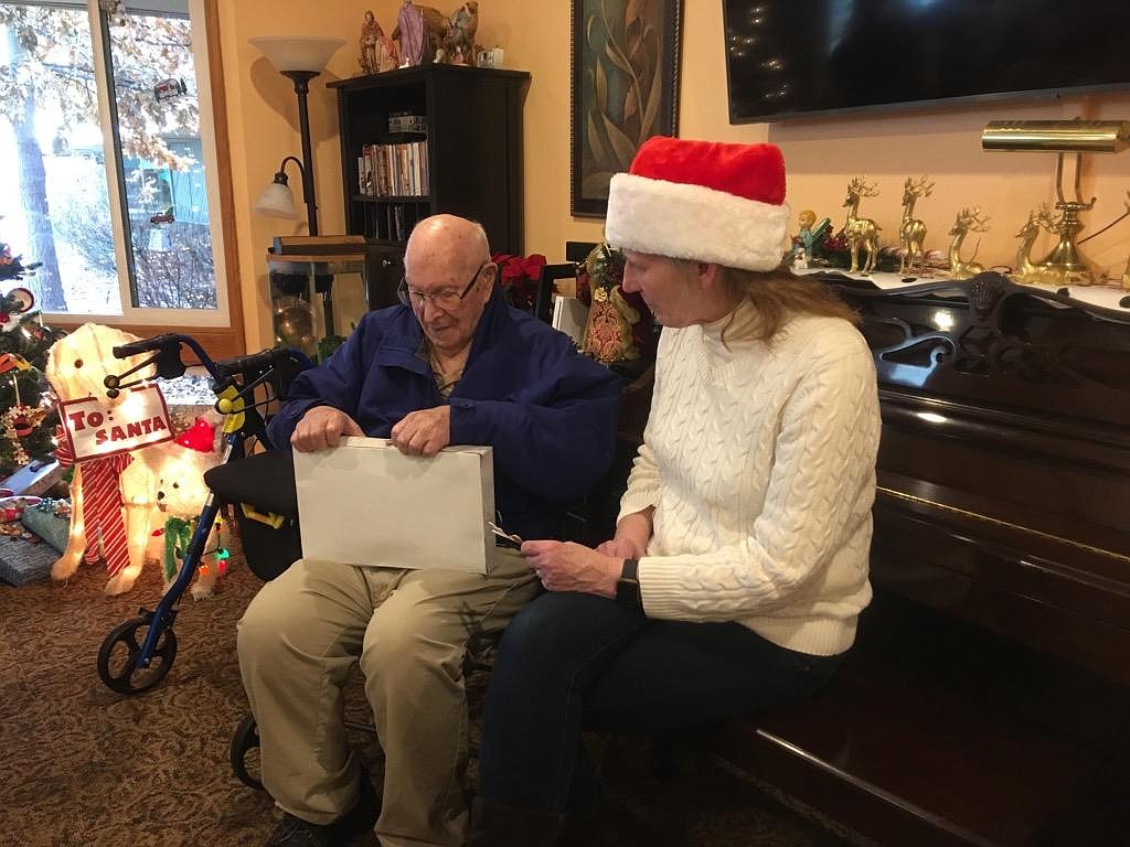 Courtesy photo 
Everybody gets a gift! Residents take some time out of their party to open a gift.