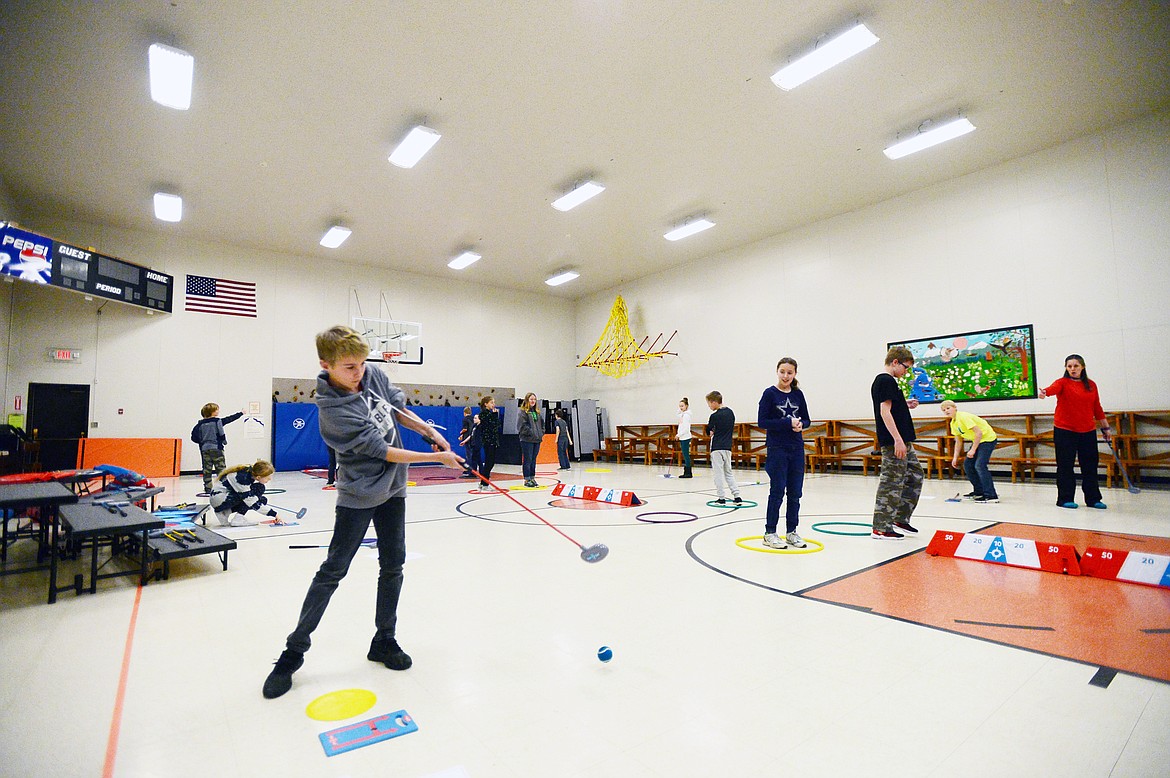 Sixth-grader Andy Tikka works on his putting skills during a golf program at Creston School.
