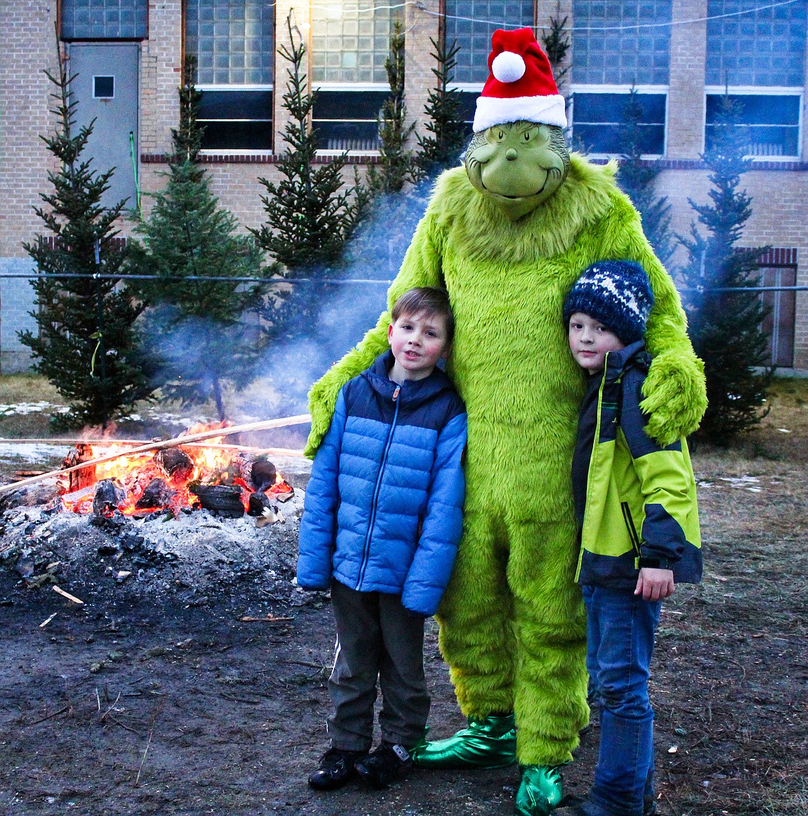 Photo by TONIA BROOKS
The Grinch, played by South Boundary Fire Department Chief, Tony Rohrwasser, took some timee off from his grinchly activities to help with the Naples Holiday Festival.