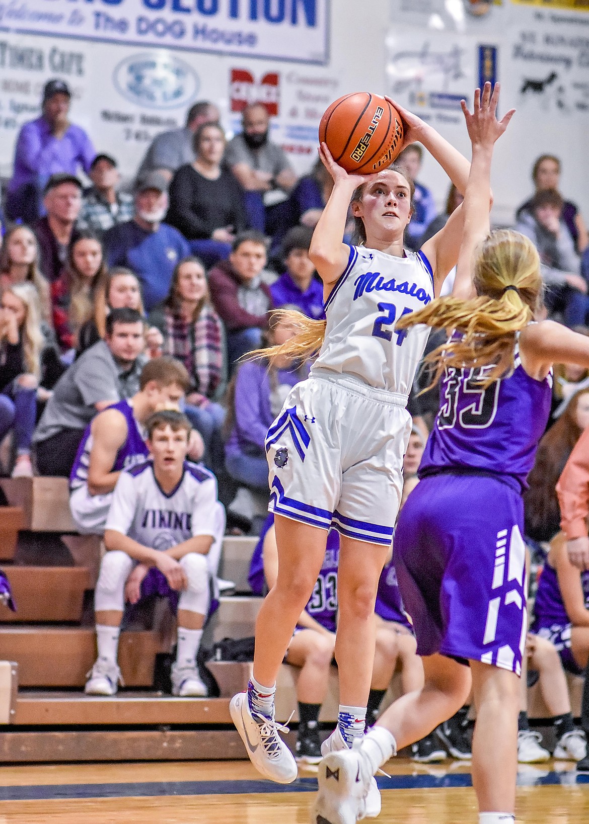 Mission Lady Bulldog junior Sydney Brander (24) launches one of seven 3-pointers she converted in the Charlo at Mission contest, four of them coming in the final frame. Applying defensive pressure is Charlo Lady Viking junior Carlee Fryberger (35). (Photo courtesy of Christa Umphrey, Forward Photography)