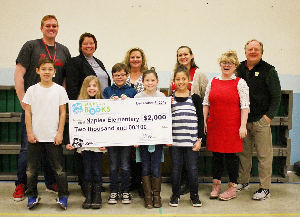 Photo by TONIA BROOKS
Representatives visited Naples Elementary School to award the $2,000 to help fund the school library. Amber Balk, the school librarian, wrote the essay to the lottery program and was instrumental in winning the award.
Front Row: Dougie Elliston,Kylie Calderone, Brandon Gardner, Kya Alderman, Emma Parker, Lottery Person
Back Row: Harmon Newhouse, Jan Bayer, Becky Schroeder of the Idaho Lottery, Amber Balk, Elizabeth Kidd of the Idaho Lottery, and David Workman of the Idaho Lottery.