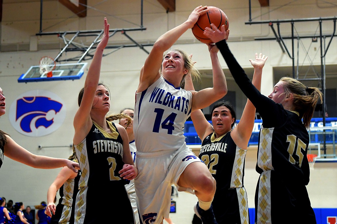 Josie Windauer goes to the basket against a trio of Stevensville defenders Saturday. Windauer scored eight as the Kats overcame a slow first half to down the Yellowjackets 59-30. (Jeremy Weber photo)