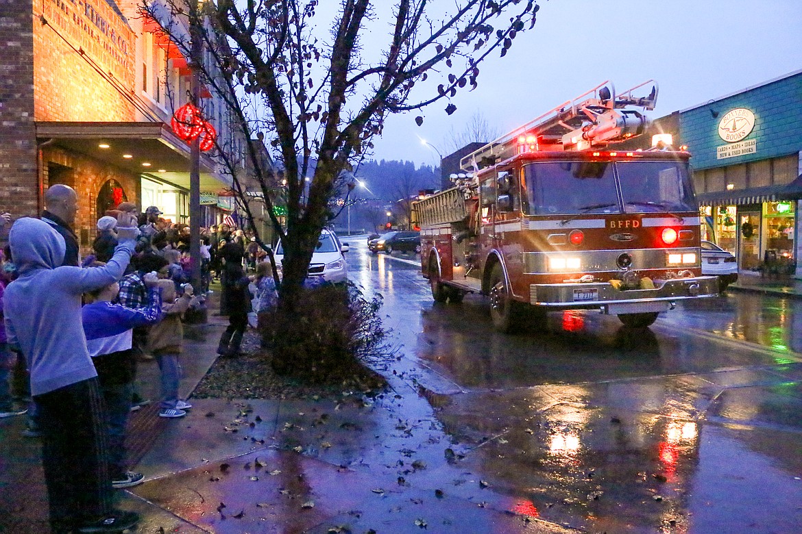 Santa and Mrs. Claus arrive in style on the fire truck.