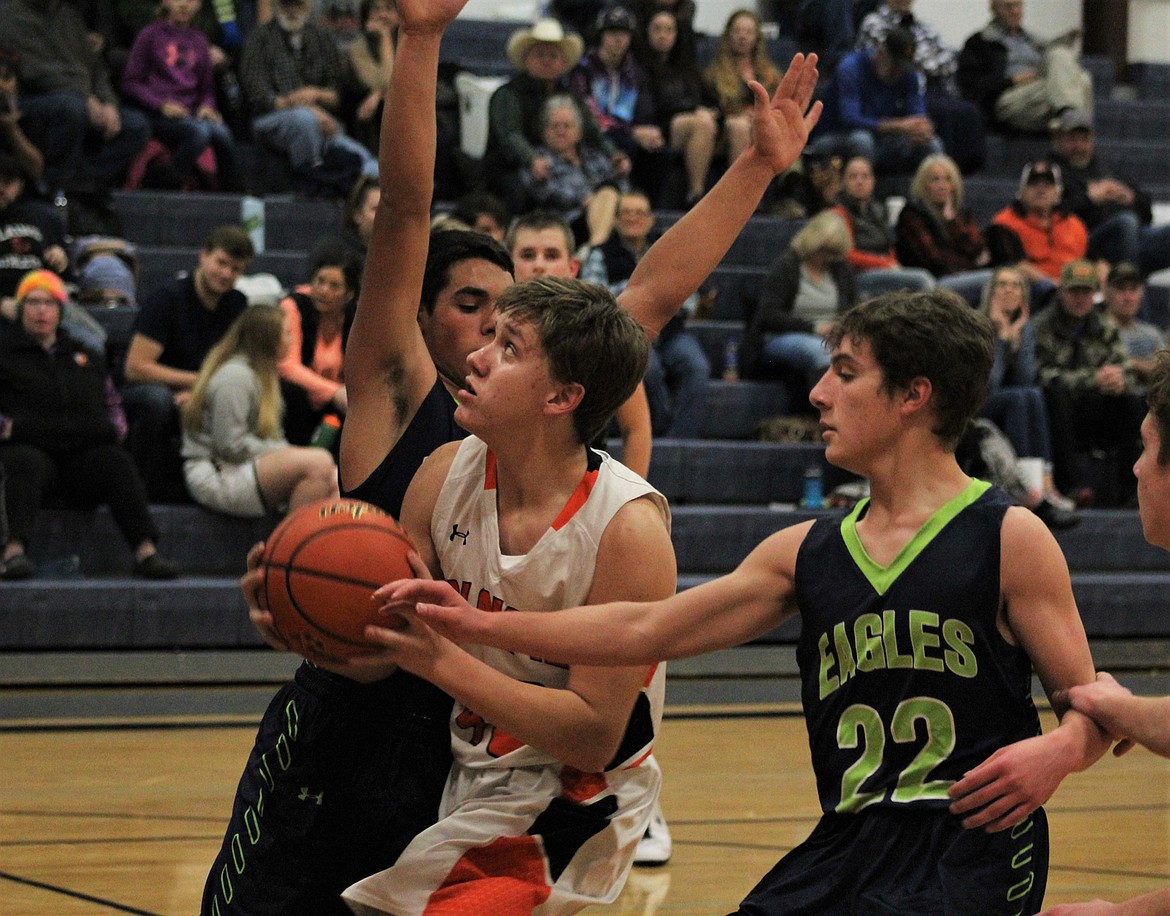 Plains&#146; Garth Parker (40) goes in for a basketball against Valley Christian in the junior varsity game Friday night. (John Dowd/Clark Fork Valley
Press)