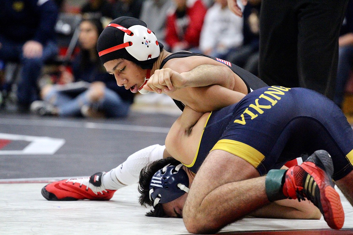 Casey McCarthy/Columbia Basin Herald Arturo Solario fights to keep his opponent down in the semifinal round on Saturday afternoon at Othello High School.