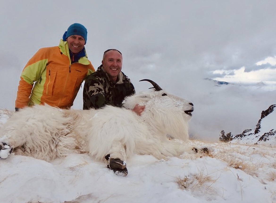 Chris Williams and Johnny Willcut, both Kalispell natives and long-time hunting buddies, pose with the mountain goat Willcut killed in the high mountains of the Absaroka-Beartooth Wilderness Nov. 10. After Willcut fell bringing the animal out, Williams made sure he got off the mountain alive. (John Willcut photo)