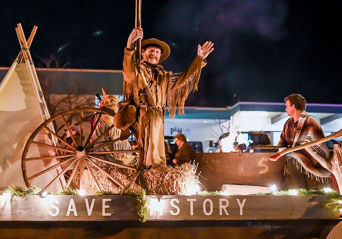 Stu Sorenson waves from the Columbia Falls Historical Society float.