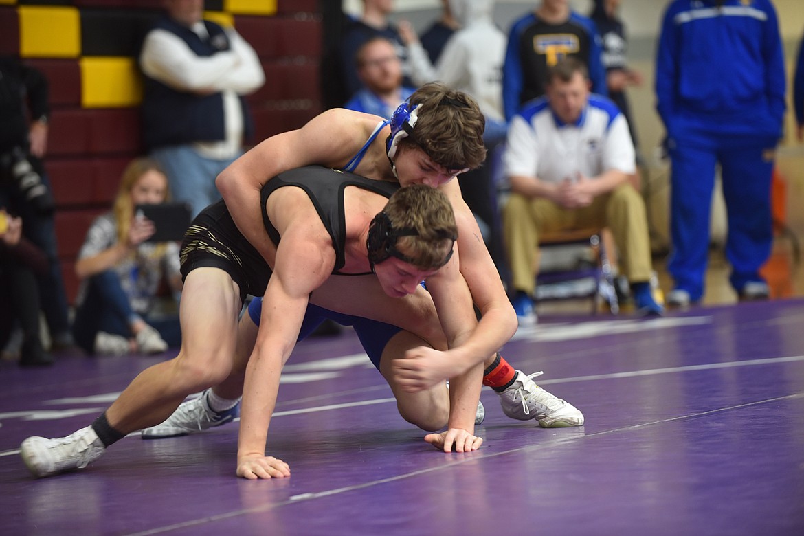 Thompson Falls wrestler Shane Reishus, top, tangles with Florence&#146;s Caden Plasmier during their 145-pound match Friday at the Owen Invitational at Salish Kootenai College in Pablo. Reishus won an 8-4 decision. (Scott Shindledecker/Clark Fork Valley Press)