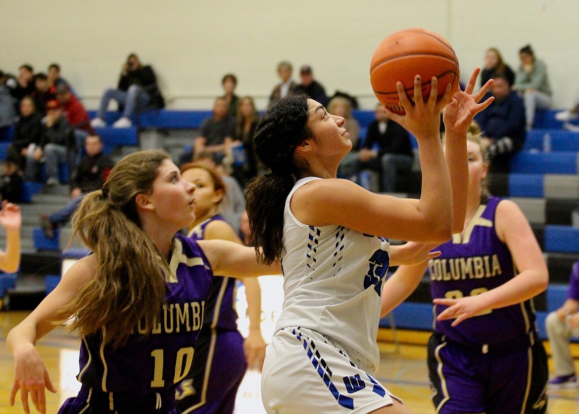 Casey McCarthy/The Sun Tribune Kiana Rios drives in for the layup for the Cougars in the win over Columbia on Tuesday night.