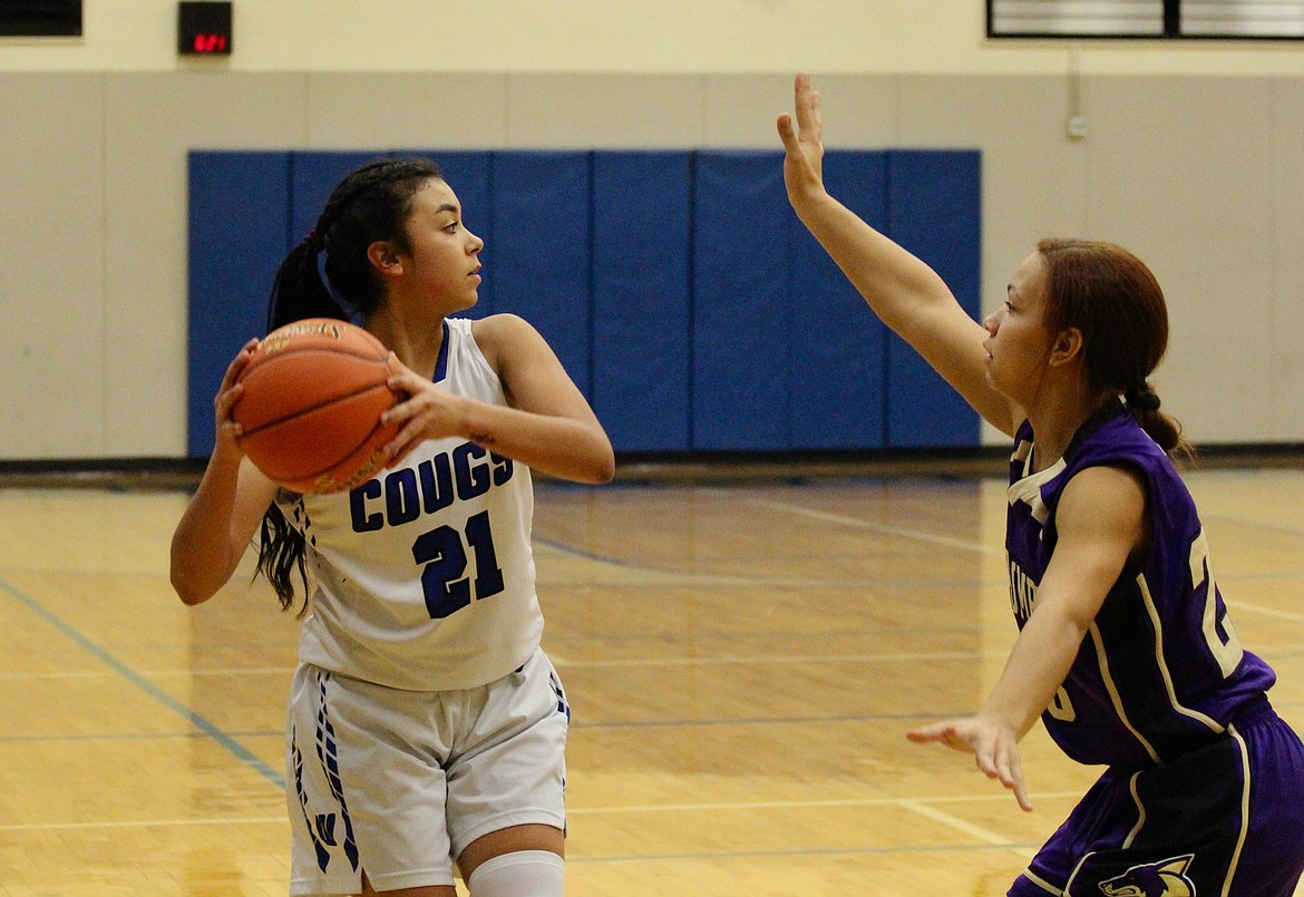 Casey McCarthy/The Sun Tribune Jlynn Rios looks for the pass with the Columbia player in defense. Rios finished with 11 points in the win on Tuesday night.