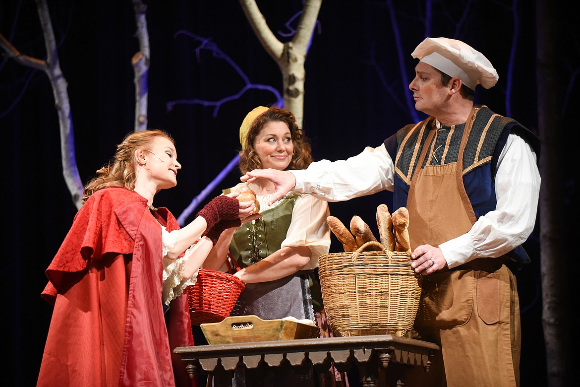 The Baker (Rob Koelzer) and his wife (Joy James) give some bred to Little Red Riding Hood (Rachel Wambeke) during a dress rehearsal of Whitefish Theater Company's &quot;Into the Woods.&quot; (Daniel McKay/Whitefish Pilot)