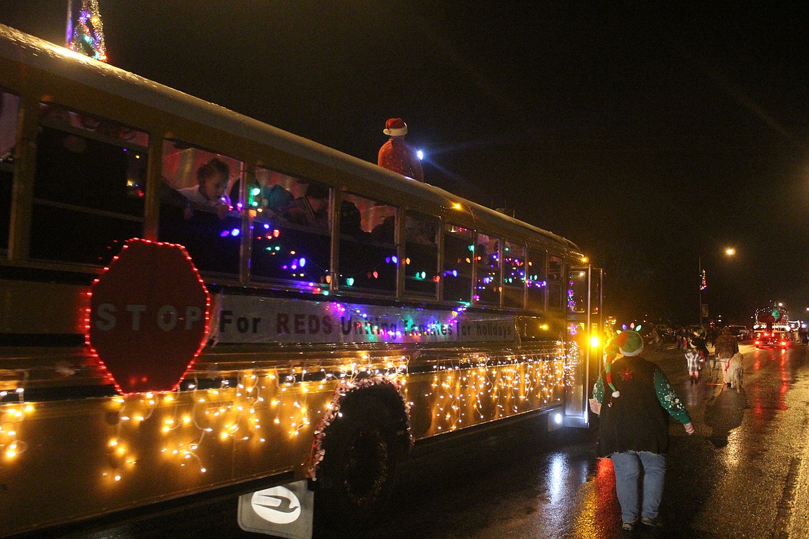 REDS for Uniting Families during the holidays school bus, decorated in Christmas lights during Saturday night&#146;s Christmas parade in downtown Thompson Falls. (John Dowd/Clark Fork Valley Press)