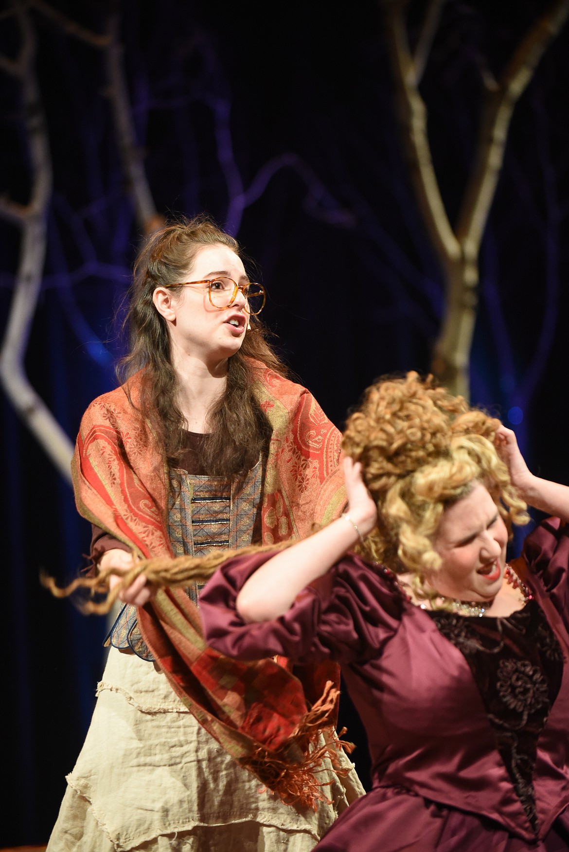 Cinderella (Sophie Sieh) violently braids the hair of Florinda (Angie Green) during a dress rehearsal of Whitefish Theater Company's &quot;Into the Woods.&quot; (Daniel McKay/Whitefish Pilot)