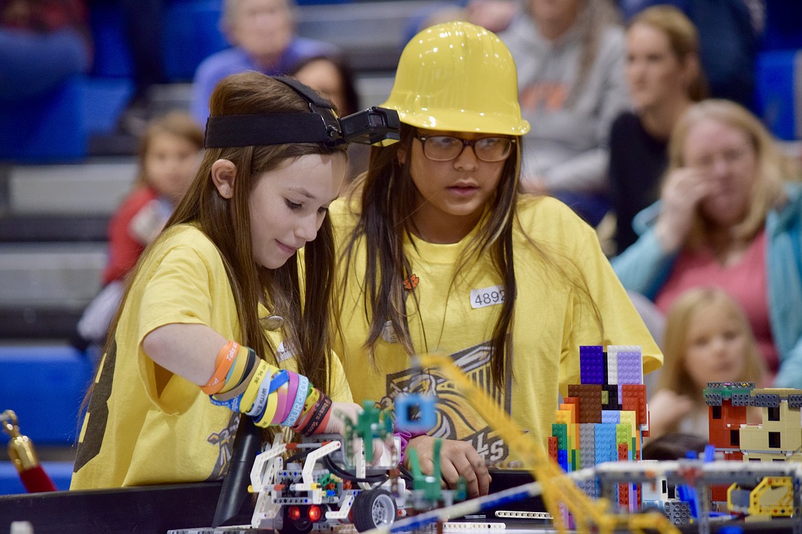 Charles H. Featherstone/Columbia Basin Herald
Royal Intermediate School fifth graders Rebecca Carlson and Rosario Bujanda rejigger their team's Lego robot during a first round of competition Saturday at the First Lego League regional match in East Wenatchee.