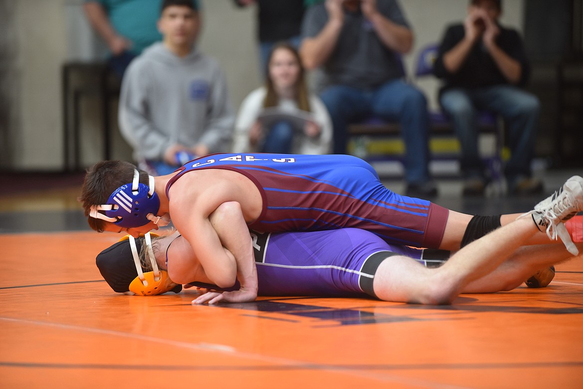 Polson&#146;s Braedon Illif, bottom, battles Clark Fork&#146;s Ryder Hansen at the Owen Invitational Friday. Illif lost the match but rallied to place fifth. (Scott Shindledecker/Lake County Leader)