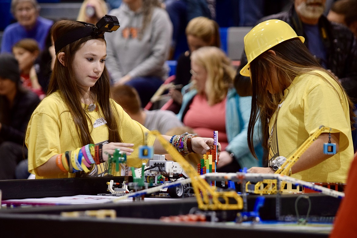 Charles H. Featherstone/Columbia Basin Herald
Royal Intermediate School fifth graders Rebecca Carlson and Rosario Bujanda rejigger their team's Lego robot during a first round of competition Saturday at the First Lego League regional match in East Wenatchee.