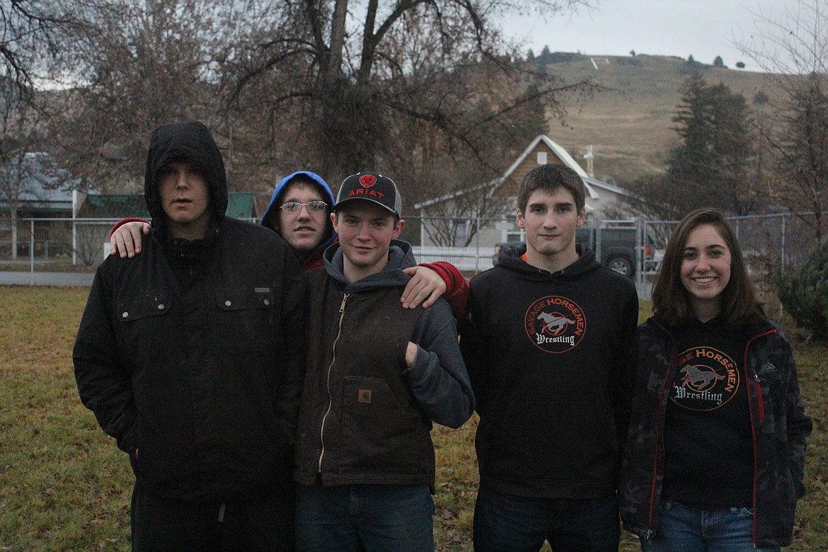 Steven Yother, Jesse Uski, Peter Carey, Conrad Vanderwall and Mykenzi Blood out in the morning last Saturday selling wreaths and trees for the wrestling team. (John Dowd/Clark Fork Valley Press)