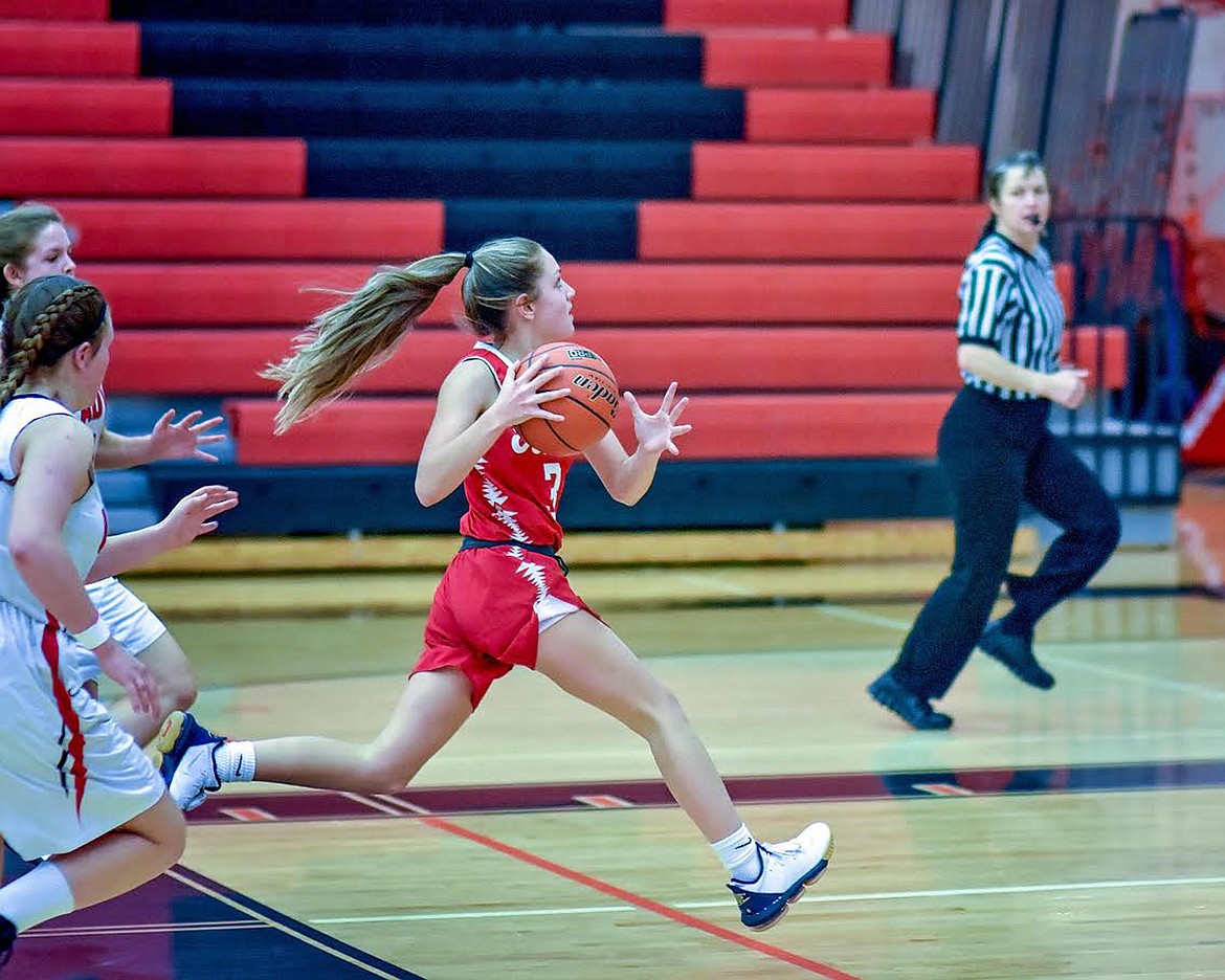 Arlee Scarlet freshman guard Jerny Crawford pushes the pace up the court at the Western C Tip-Off at Ronan. (Photo courtesy of Christa Umphrey, Forward Photography)