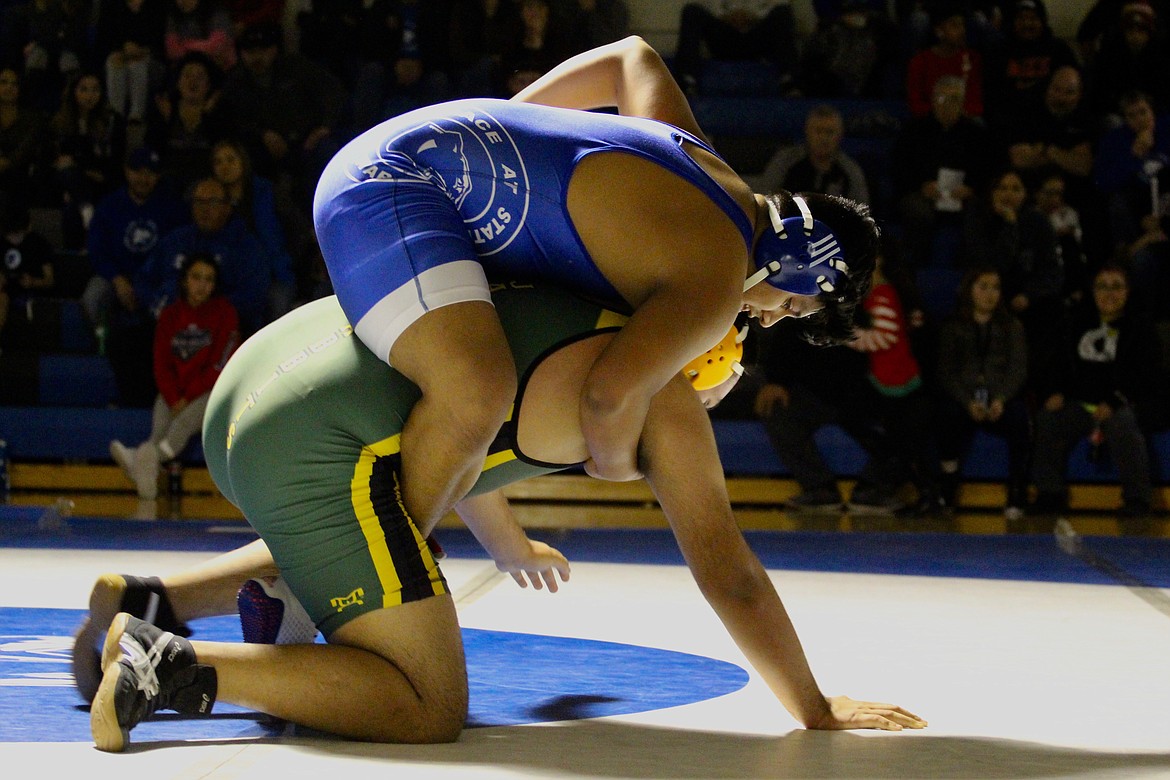 Casey McCarthy/Sun Tribune 
Quincy&#146;s Migeul Martinez fights to hold up Warden&#146;s Eduardo Suarez on top of him in the matchup at 285 at Thursday&#146;s wrestling dual at Warden High School.