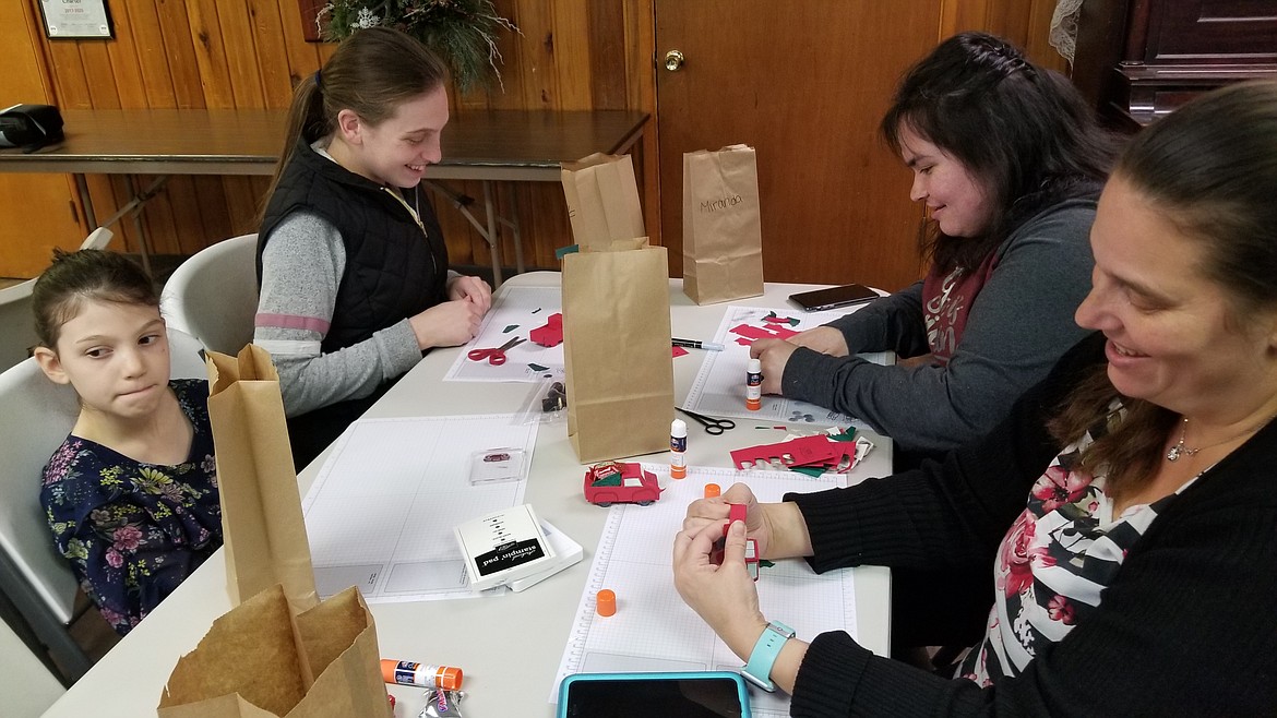 The Cowell family, Bella, Katie, Miranda, and Cat, all working on their crafting projects.