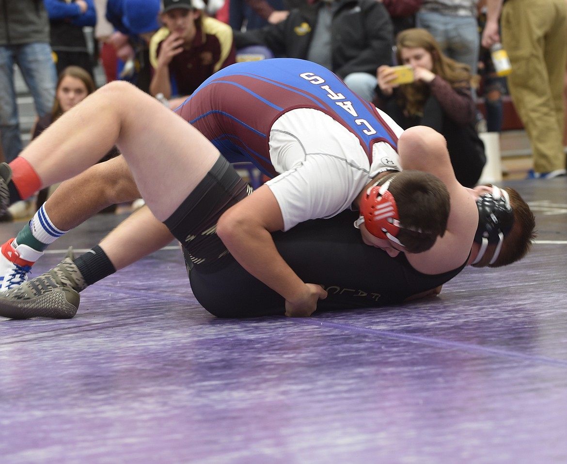 Chandon Vulles of Clark Fork puts Florence&#146;s Jared Pallo on his back during their match at 205 pounds Friday at the Owen Invitational at Salish Kootenai College in Pablo. Vulles scored a pin in 1:22. (Scott Shindledecker/Mineral Independent)