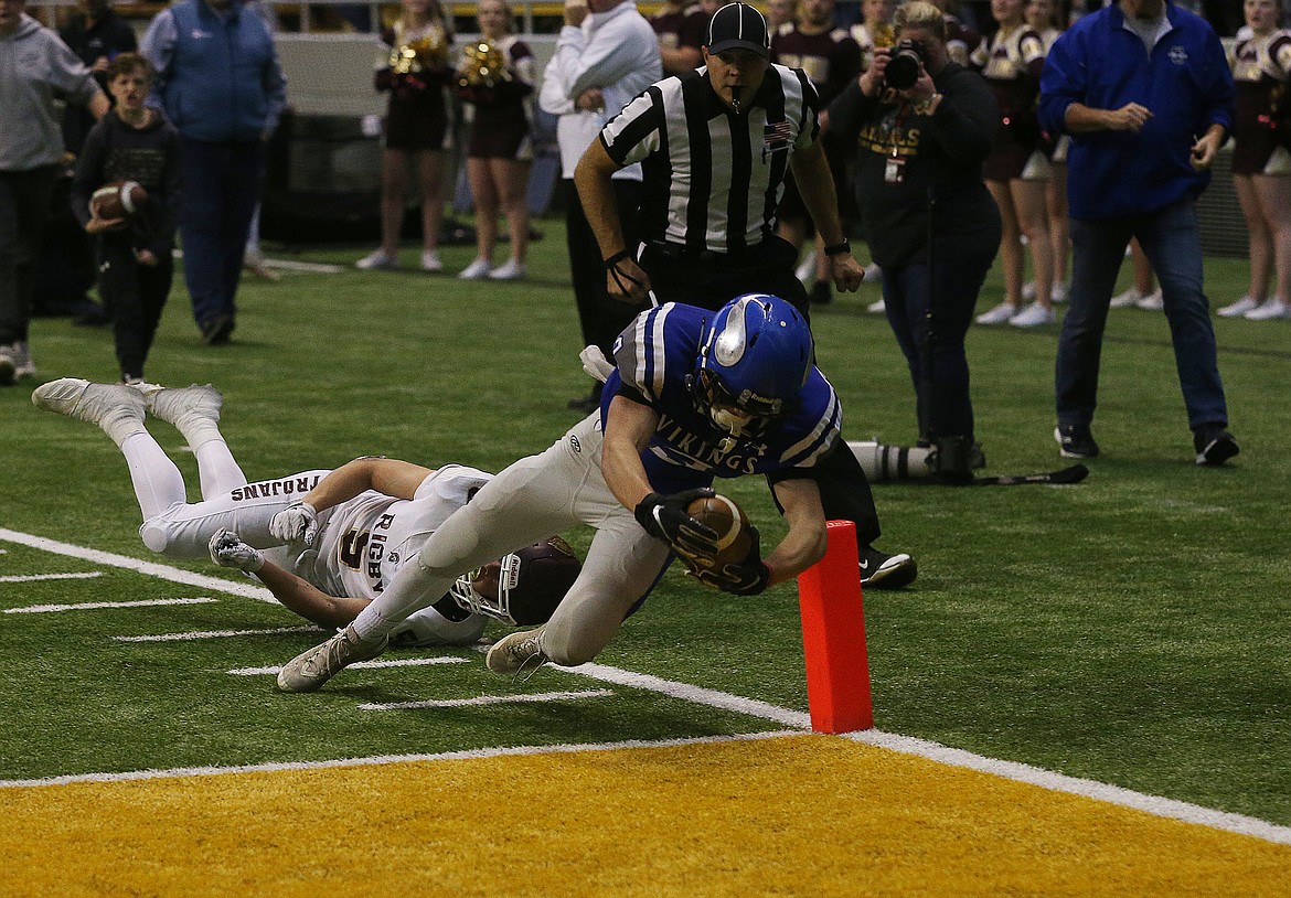 Coeur d'Alene's Jake Brown dives over the pylon for a touchdown against Rigby in the 5A Idaho State Championship game Saturday at the Kibbie Dome. (LOREN BENOIT/Press)