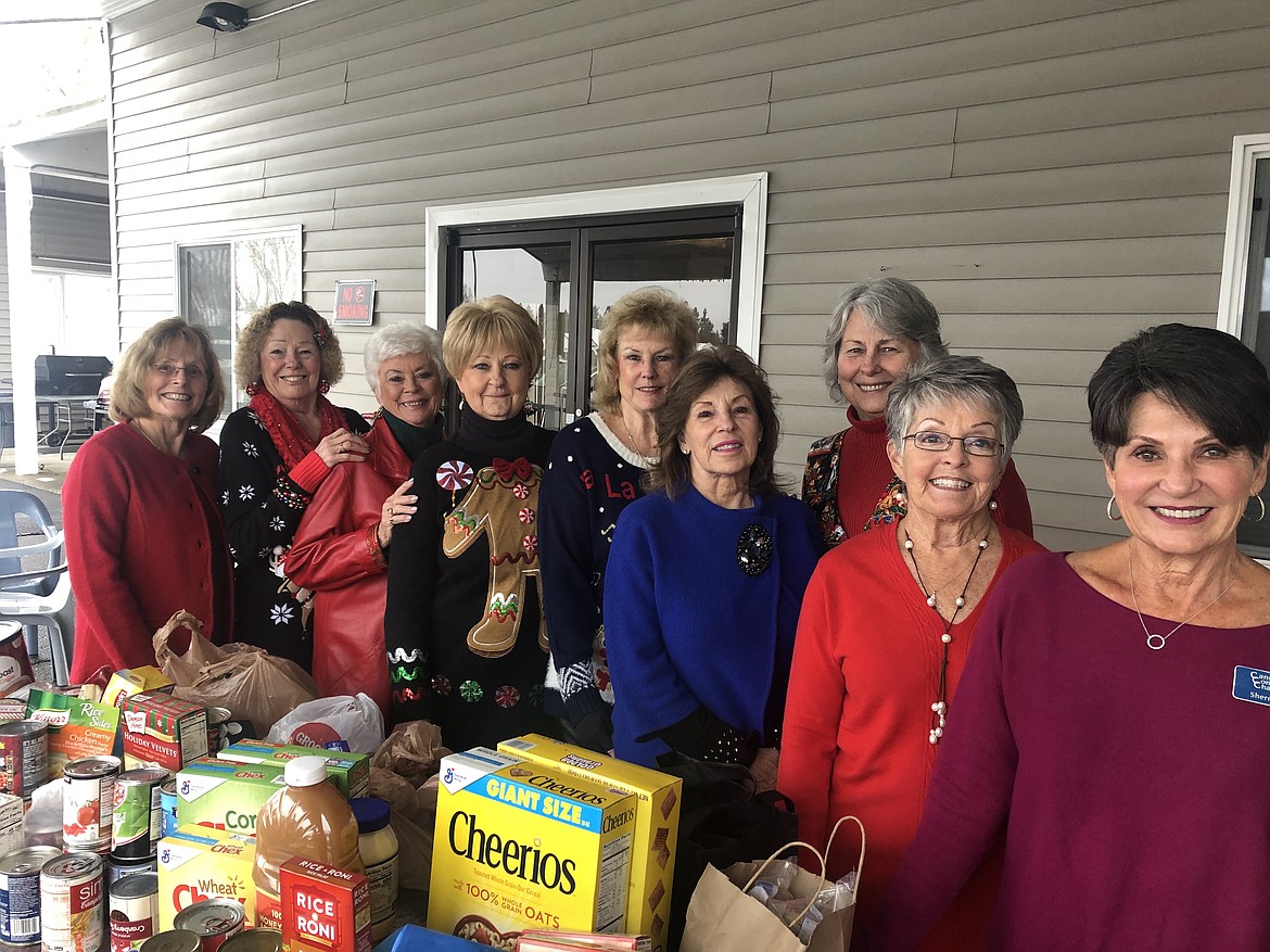 Neither rain, sleet, or snow could keep the 3Cs (Cancer &amp; Community Charities) from celebrating Christmas at The Elks Lodge while collecting food and monetary donations for the Kootenai Humane Society and the Community Action Partnership Food Bank. Pictured from left: Betsy Martin, Sally Barnett, 3Cs President Barbara Newland, Barb Stongle, Shaaron Dominguez, Jeannine Crum, Donna Evans, Linda Pedersen and Sherry Beno. (Courtesy photo)