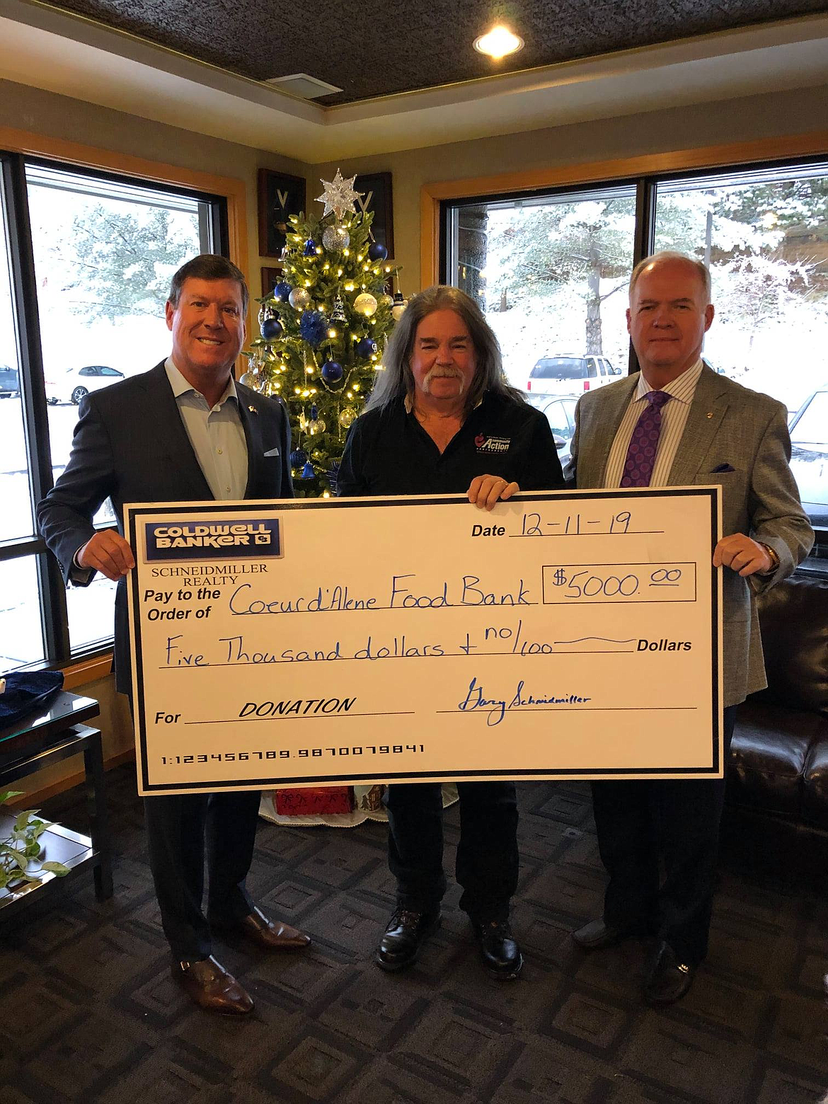 Mark Johnson, CEO and president of Coldwell Banker Schneidmiller Realty; Darrell Rickard, Coeur d&#146;Alene Food Bank program manager; and Gary Schneidmiller, Broker-Founder-Chairman Coldwell Banker Schneidmiller Realty.