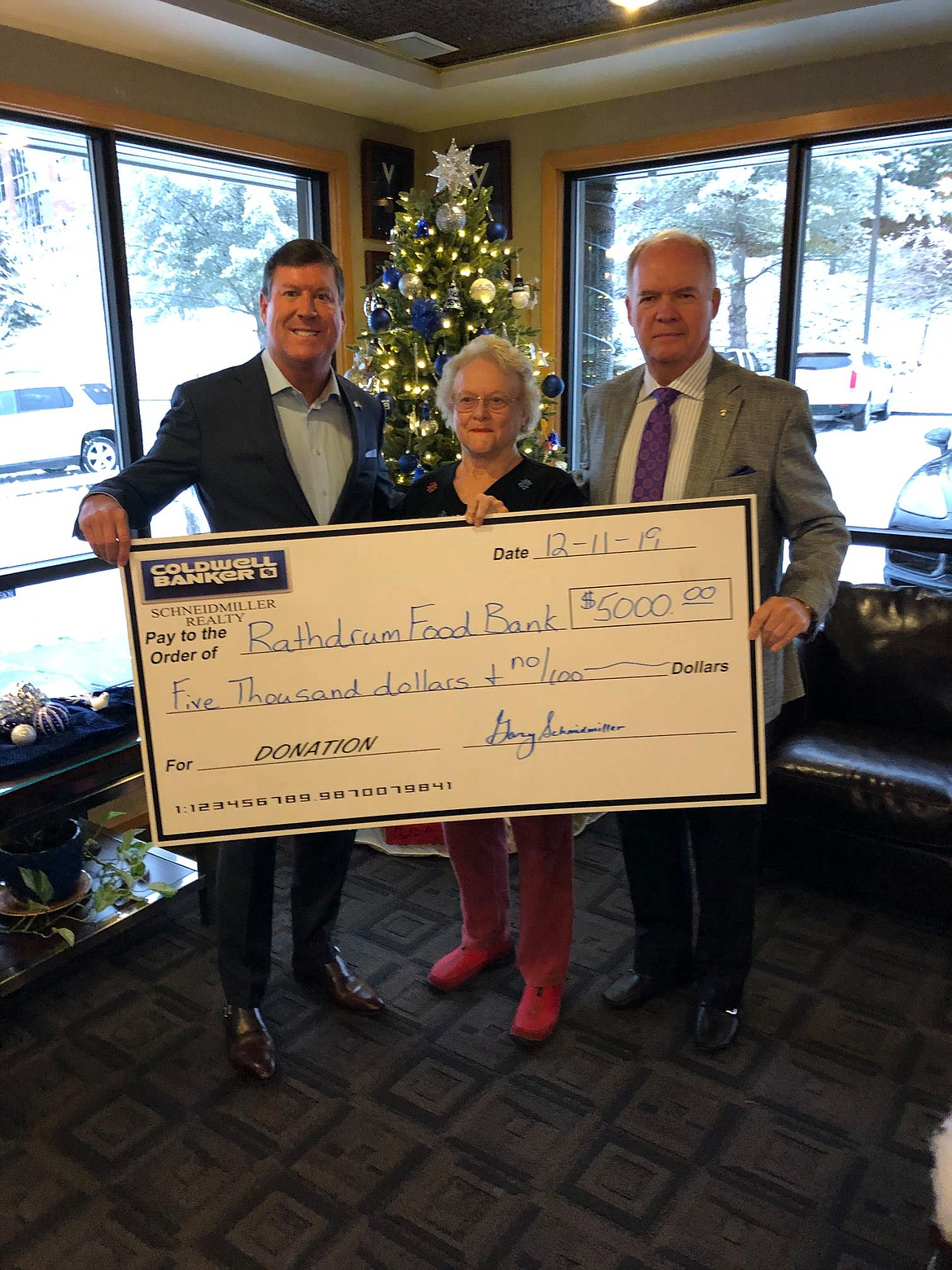 Pictured here are Mark Johnson, president and CEO of Coldwell Banker Schneidmiller Realty; Sharon Dillon, Rathdrum Food Bank and Gary Schneidmiller, broker, founder and chairman of Coldwell Banker Schneidmiller Realty.