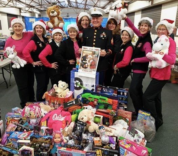 The Blazen Divaz said &#147;it&#146;s all about the children,&#148; when they banded together to gather toys, clothes and necessities for Toys for Tots with the Marine Corps League of Coeur d&#146;Alene, which was founded in 1947. From left: Doreen Kruger, Mary Lien, Gerry Riffel, Shelley Webb, Julia Parmann, Sgt. Mike Quin, Carol Slgo, Mary Pettit, Julia Magnan and Debra Moore. (Courtesy photo)