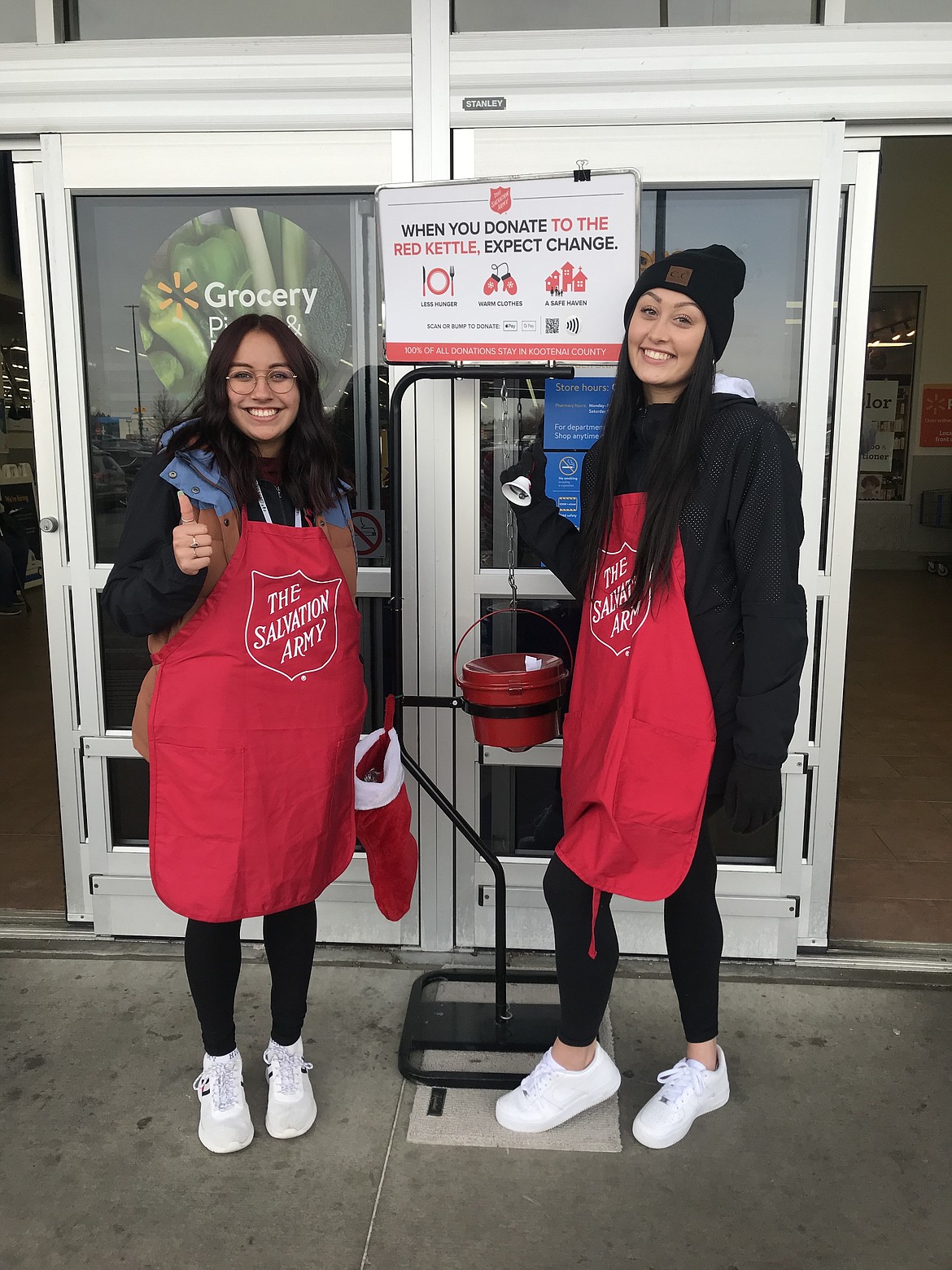 Several North Idaho College Athletics teams rang the Salvation Army red kettle bells this holiday season, raising about $2,230 for the nonprofit that clothes, feeds, and shelters families. Pictured are NIC women&#146;s volleyball players Tynn Christiansen (left) and Hannah McPhetridge ringing the red bell for the Salvation Army red kettle in front of Fred Meyer earlier this month. (Courtesy photo)