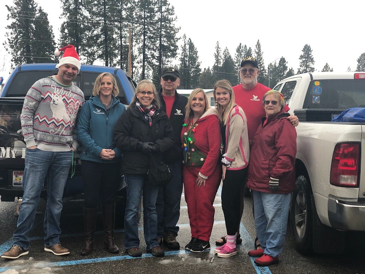 From left: Lakeland Junior High School Principal Harrison Bertsch, Newby-ginning staff members along with Theresa Hart of Newby-ginnings North Idaho, Assistant Principal Keri Murphy, Principal Assistant Francesca Myers, and Sharon Dillion with Rathdrum Food Bank.