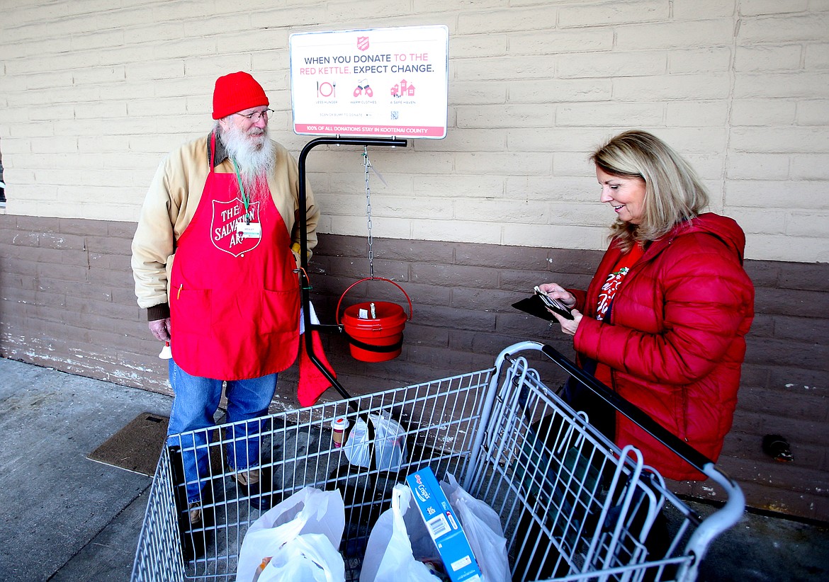 LOREN BENOIT/Press
Salvation Army kettle worker Wesley Winberry interacts with Jennifer Morton outside of Super 1 Foods in Hayden on Christmas Eve.